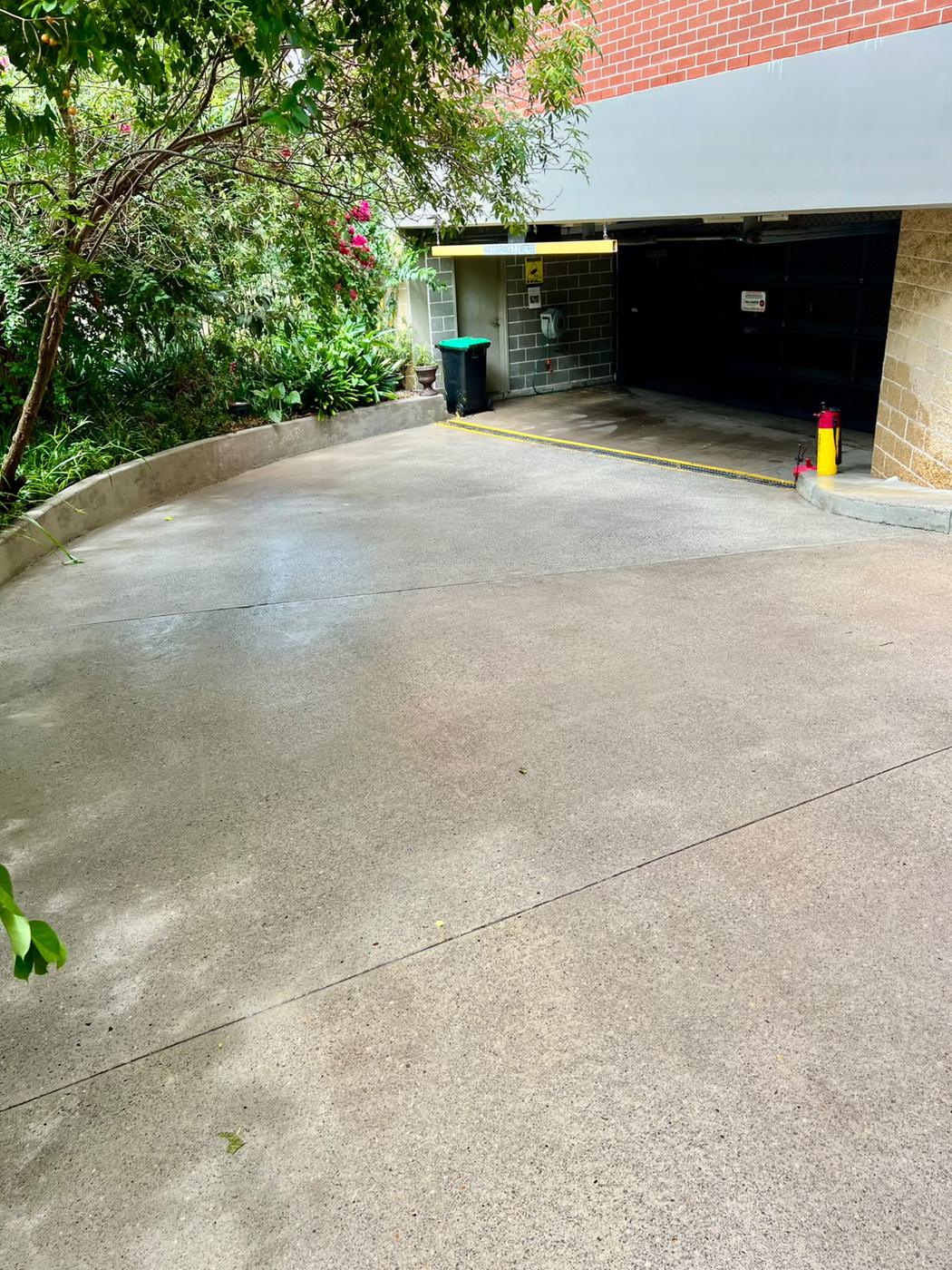 Same garage ramp and driveway freshly cleaned after pressure washing