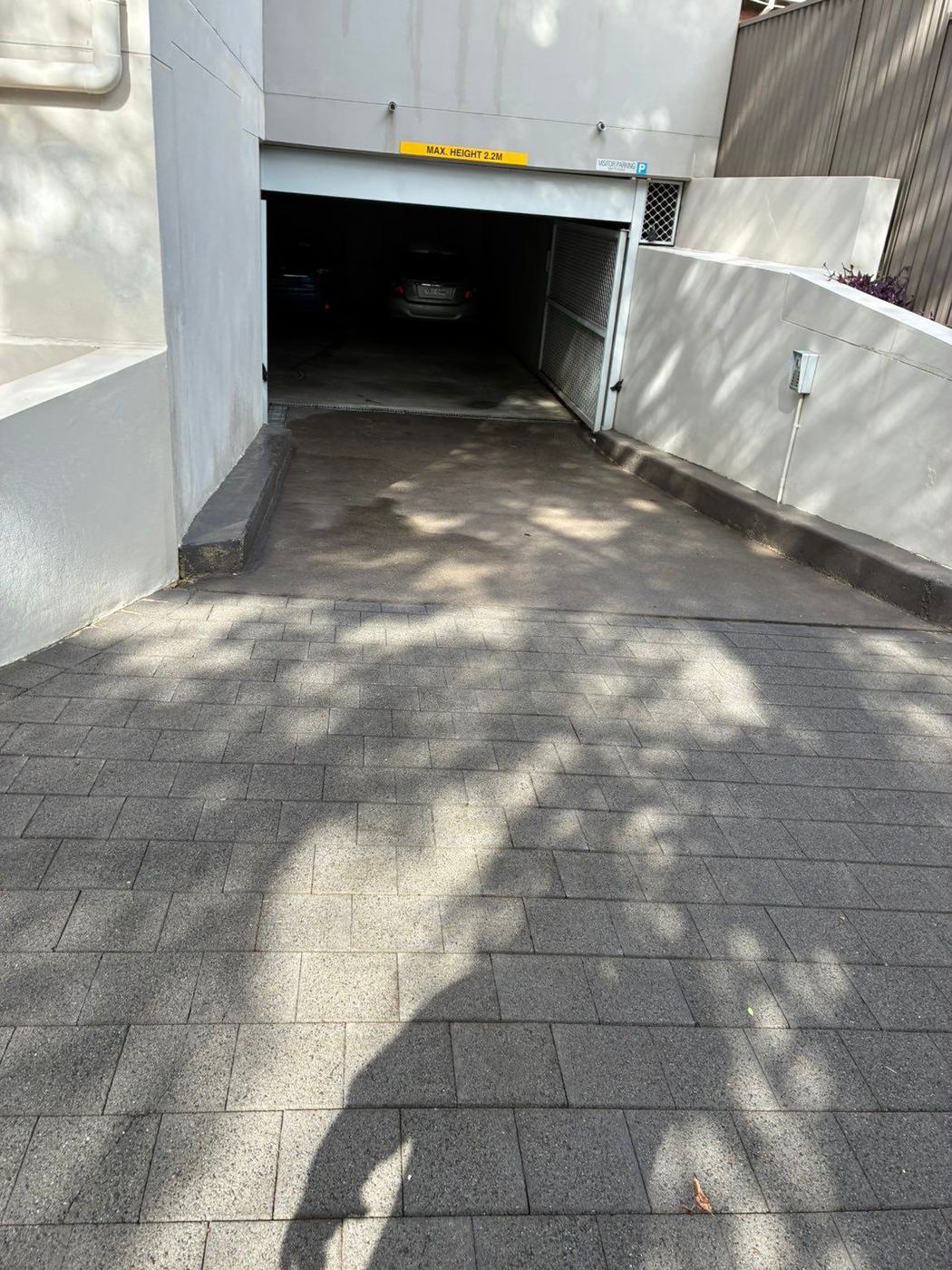 Same driveway ramp restored to clean pavers after pressure washing