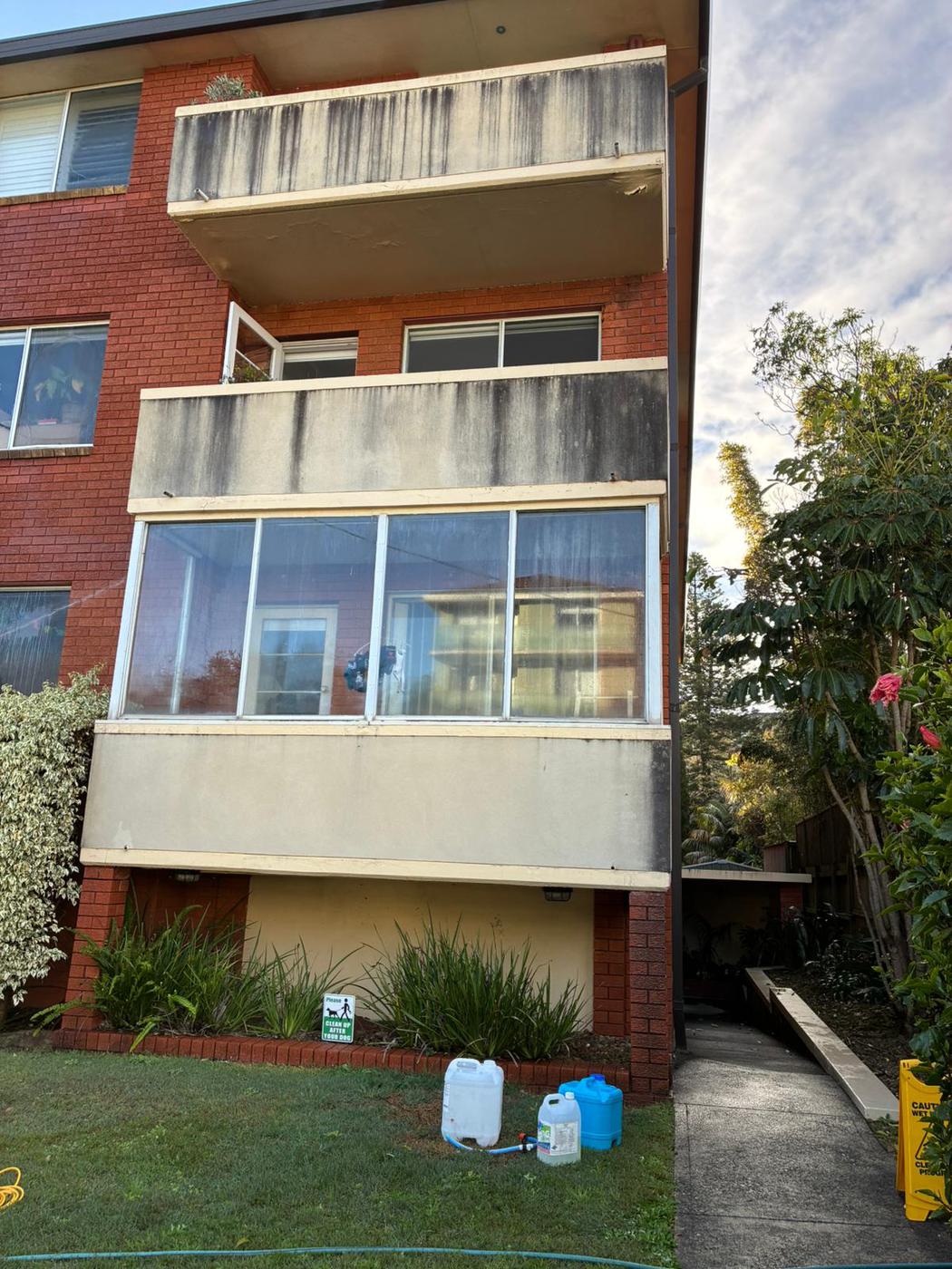 Mould-stained apartment balconies before pressure washing