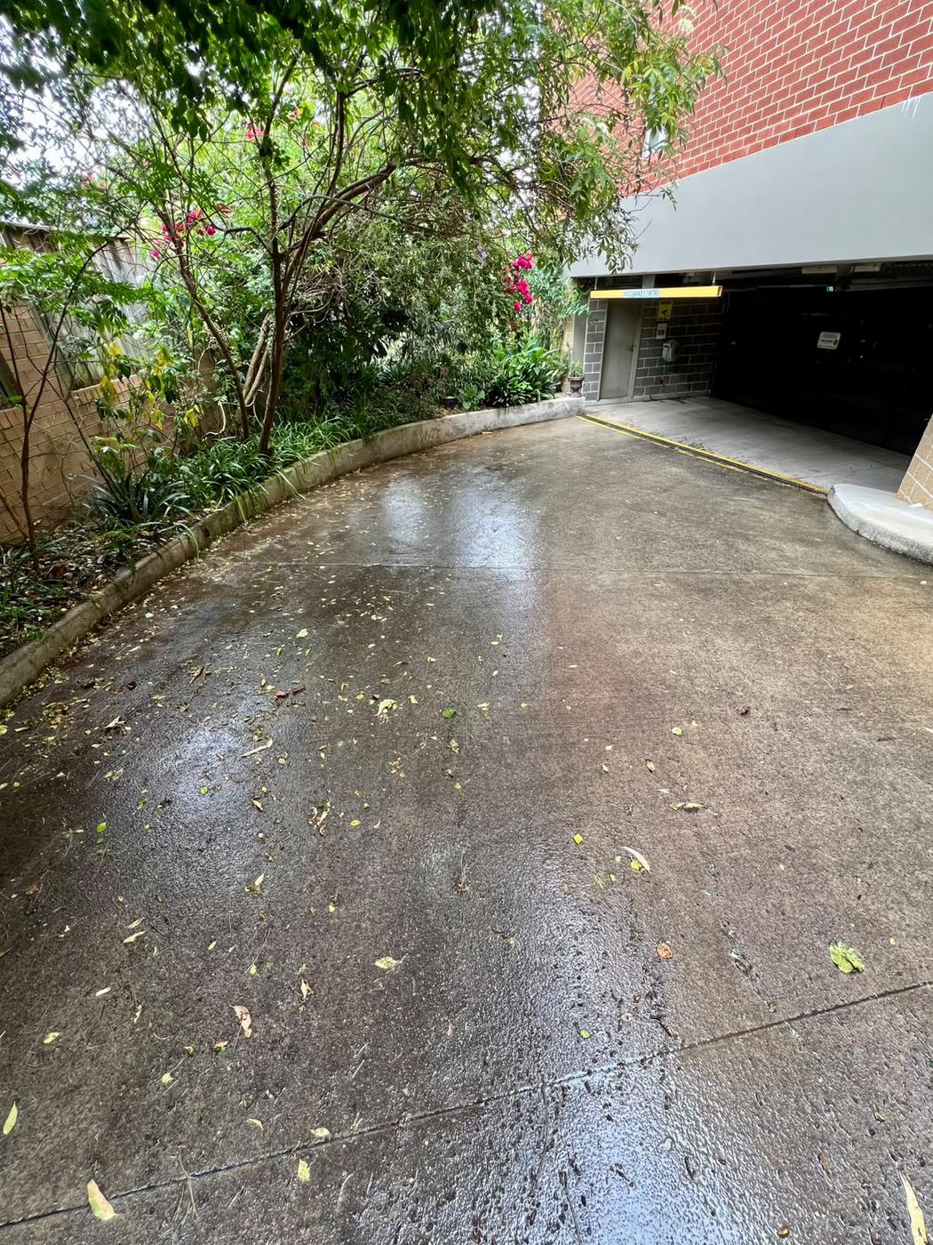 Apartment garage ramp and driveway before pressure washing