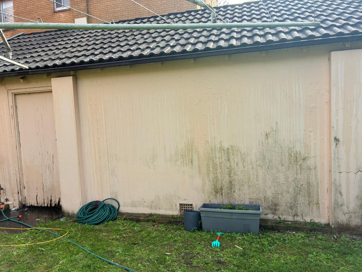 Same garage wall restored after pressure washing